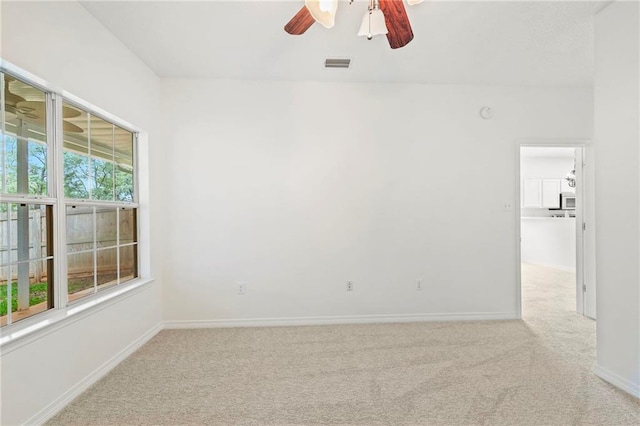 unfurnished room featuring light carpet and ceiling fan