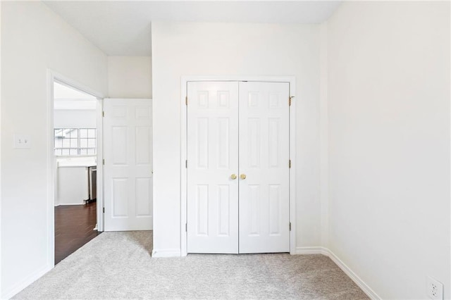 unfurnished bedroom with a closet and carpet