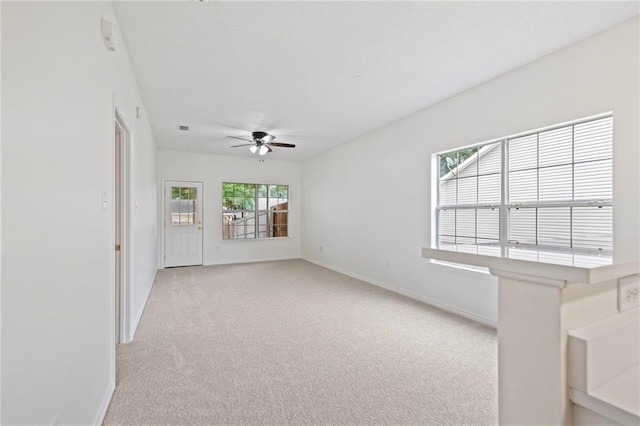 unfurnished room with ceiling fan and light colored carpet