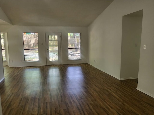 6290 Quail Ct, Theodore, AL 36582 - unfurnished room with plenty of natural light, dark wood finished floors, vaulted ceiling, and baseboards