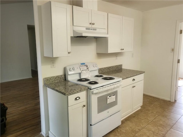 6290 Quail Ct, Theodore, AL 36582 - kitchen with under cabinet range hood, white electric range oven, white cabinetry, and baseboards