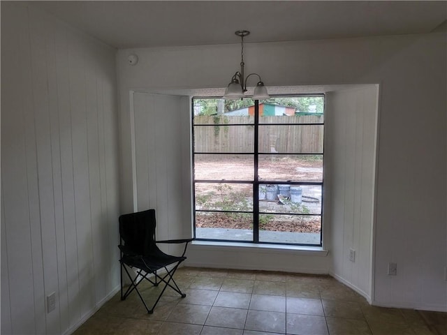 6290 Quail Ct, Theodore, AL 36582 - sitting room with a chandelier, plenty of natural light, tile patterned flooring, and wooden walls