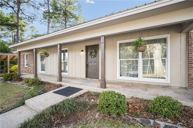 view of exterior entry with covered porch