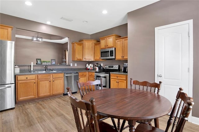 kitchen featuring visible vents, light wood-style flooring, recessed lighting, a sink, and stainless steel appliances