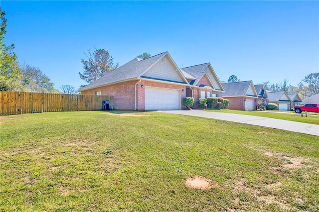 view of front facade with brick siding, an attached garage, fence, a front yard, and driveway