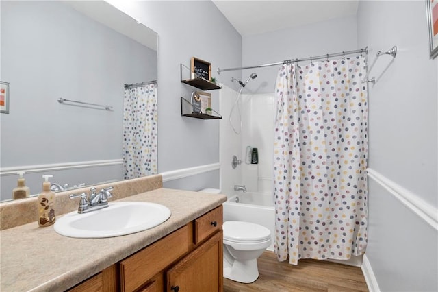 full bathroom featuring vanity, toilet, wood finished floors, and shower / bath combo