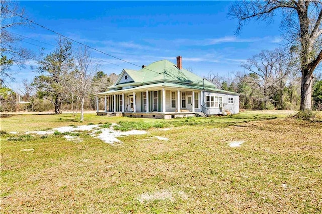 52780 State Highway 59, Stockton, AL 36579 - rear view of house with a porch, a lawn, and a chimney
