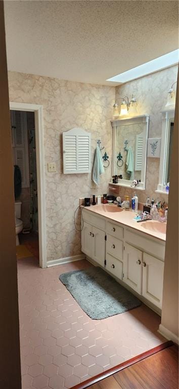 6325 Shadowlake Ct, Mobile, AL 36693 - full bathroom featuring double vanity, a textured ceiling, and a skylight