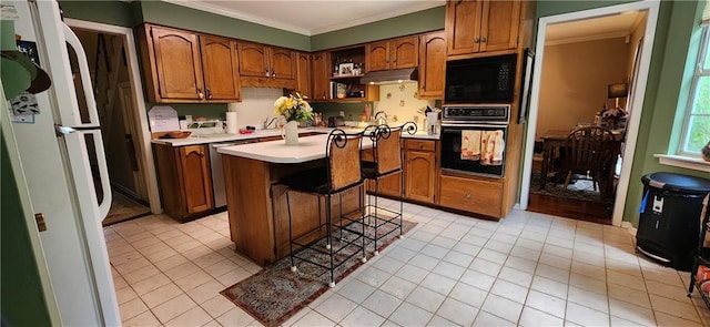 6325 Shadowlake Ct, Mobile, AL 36693 - kitchen featuring black appliances, under cabinet range hood, ornamental molding, light countertops, and open shelves