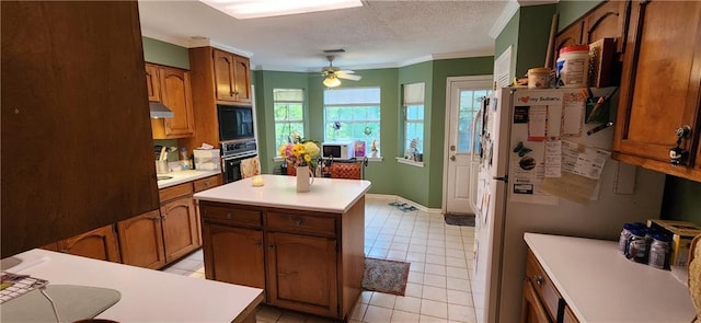6325 Shadowlake Ct, Mobile, AL 36693 - kitchen featuring black appliances, under cabinet range hood, ornamental molding, light countertops, and ceiling fan