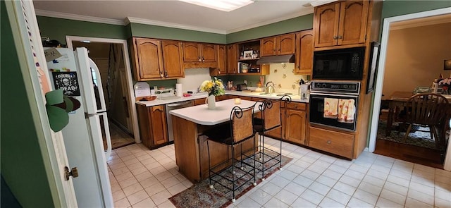 6325 Shadowlake Ct, Mobile, AL 36693 - kitchen featuring black appliances, under cabinet range hood, light countertops, ornamental molding, and light tile patterned flooring