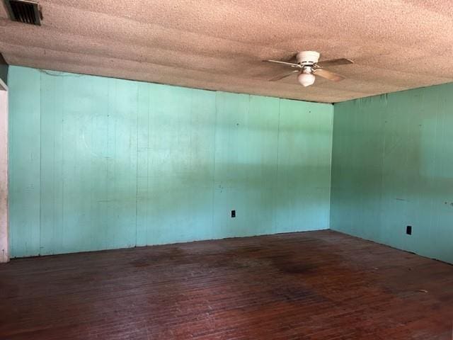15131 Moffett Rd, Wilmer, AL 36587 - unfurnished room featuring visible vents, hardwood / wood-style floors, and ceiling fan