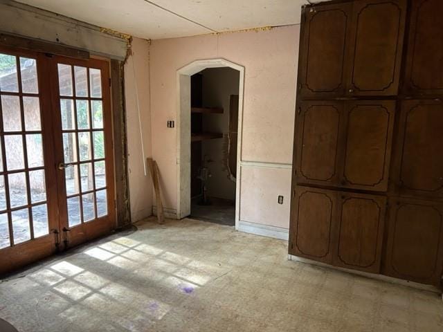15131 Moffett Rd, Wilmer, AL 36587 - unfurnished room with arched walkways, french doors, and light floors