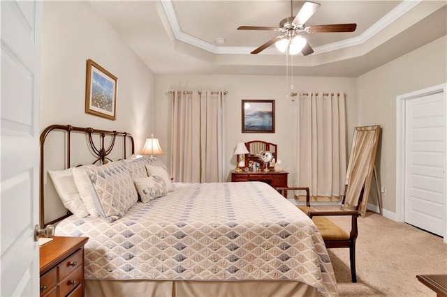 bedroom featuring crown molding, carpet, ceiling fan, and a tray ceiling