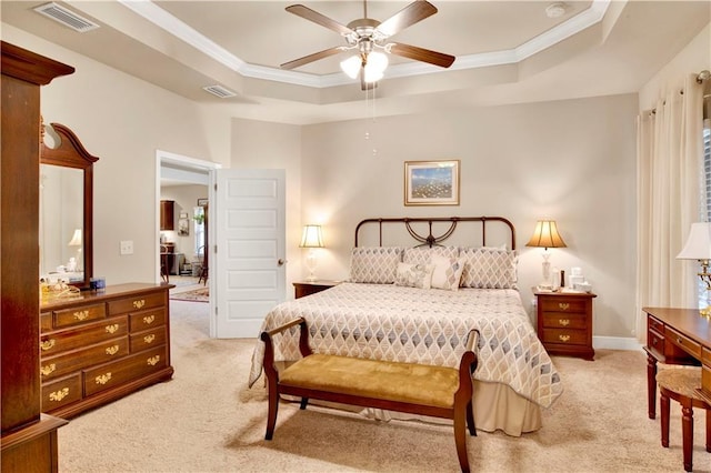 bedroom with ornamental molding, light colored carpet, ceiling fan, and a tray ceiling