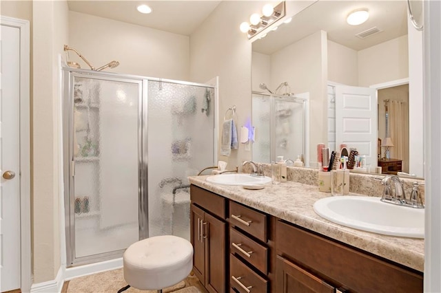 bathroom featuring vanity and an enclosed shower