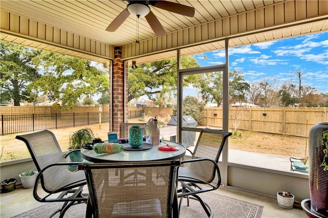 sunroom with ceiling fan and a healthy amount of sunlight