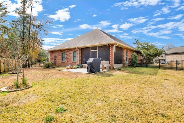 rear view of house featuring a patio and a lawn