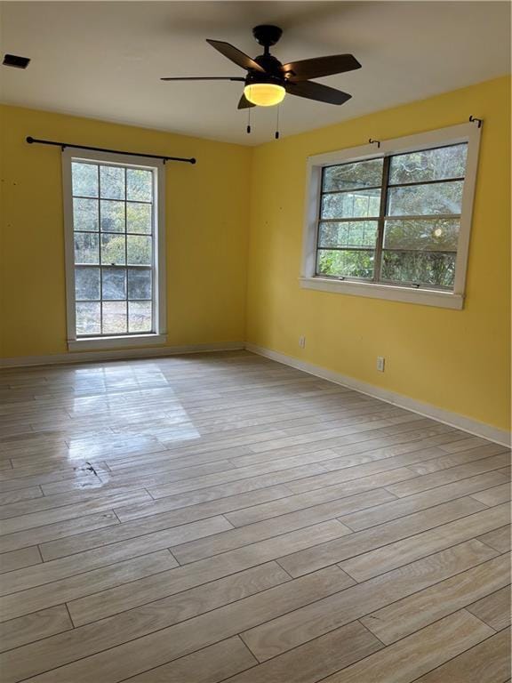 unfurnished room with light hardwood / wood-style floors and ceiling fan