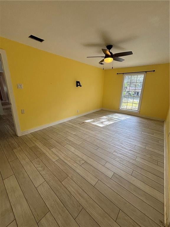 unfurnished room with light wood-type flooring and ceiling fan