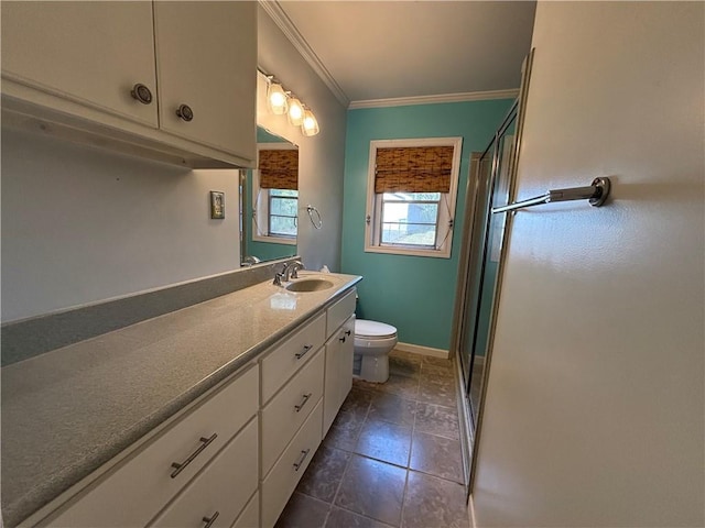 bathroom featuring vanity, toilet, a shower with shower door, and crown molding