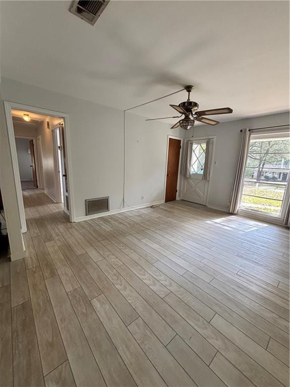 spare room featuring ceiling fan and light hardwood / wood-style floors