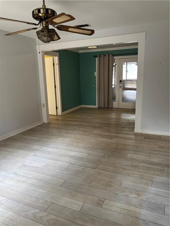 spare room with light hardwood / wood-style flooring and ceiling fan