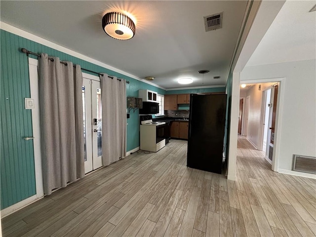 kitchen featuring light hardwood / wood-style floors and black appliances