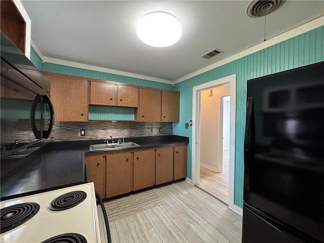 kitchen featuring sink, decorative backsplash, ornamental molding, fridge, and white range with electric stovetop