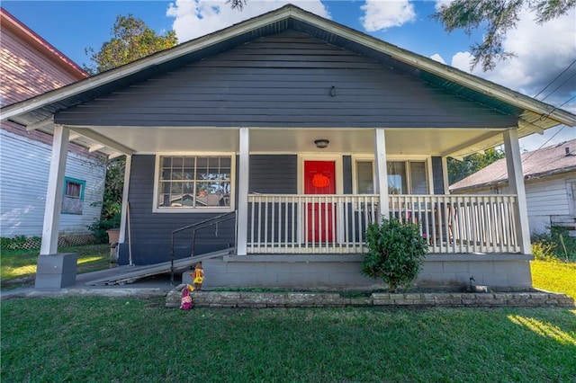 bungalow-style home with a front yard