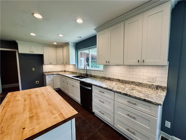 kitchen with dark tile floors, sink, backsplash, black dishwasher, and butcher block counters