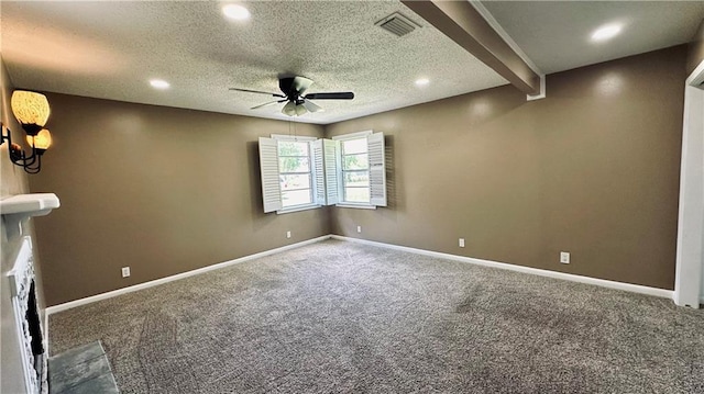 carpeted spare room featuring beam ceiling, ceiling fan, and a textured ceiling