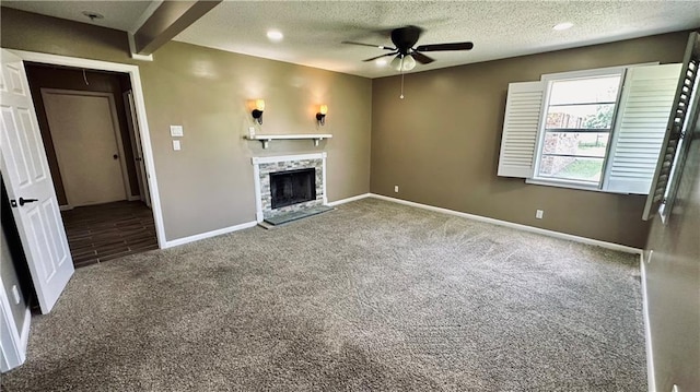 unfurnished living room featuring carpet, beam ceiling, ceiling fan, and a textured ceiling