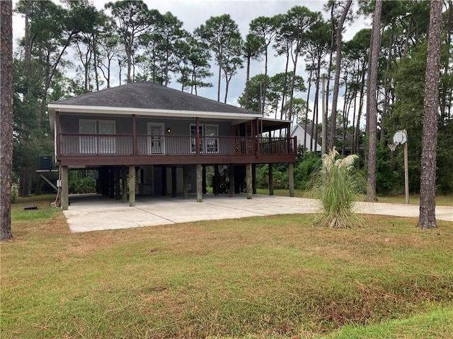 back of house featuring a lawn and a carport