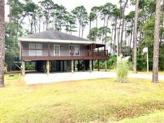 rear view of property with a lawn