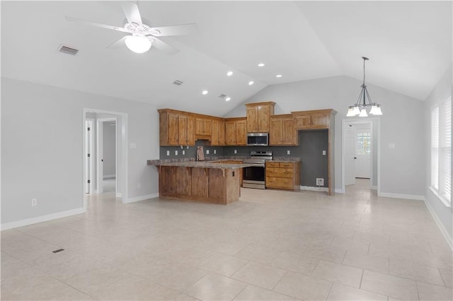 kitchen with visible vents, brown cabinetry, appliances with stainless steel finishes, a kitchen breakfast bar, and ceiling fan with notable chandelier