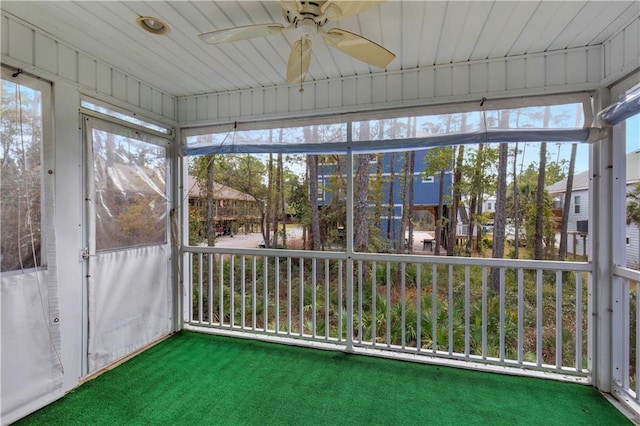 unfurnished sunroom with a wealth of natural light and a ceiling fan