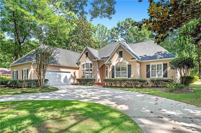 104 Ferncliff Cir, Daphne, AL 36526 - view of front of home featuring stucco siding, concrete driveway, a garage, and a front yard