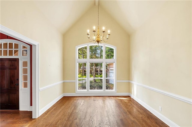 104 Ferncliff Cir, Daphne, AL 36526 - unfurnished dining area with a chandelier, wood finished floors, high vaulted ceiling, and baseboards