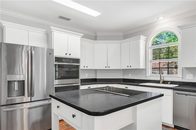 104 Ferncliff Cir, Daphne, AL 36526 - kitchen with stainless steel appliances, a sink, white cabinetry, a kitchen island, and crown molding
