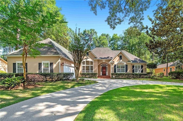 104 Ferncliff Cir, Daphne, AL 36526 - view of front of home featuring stucco siding, a front yard, and a garage