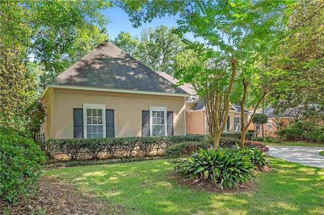 104 Ferncliff Cir, Daphne, AL 36526 - view of front of property with stucco siding, a front lawn, and roof with shingles
