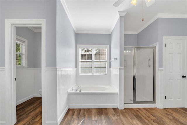 104 Ferncliff Cir, Daphne, AL 36526 - bathroom featuring a bath, a shower stall, wood finished floors, a wainscoted wall, and toilet
