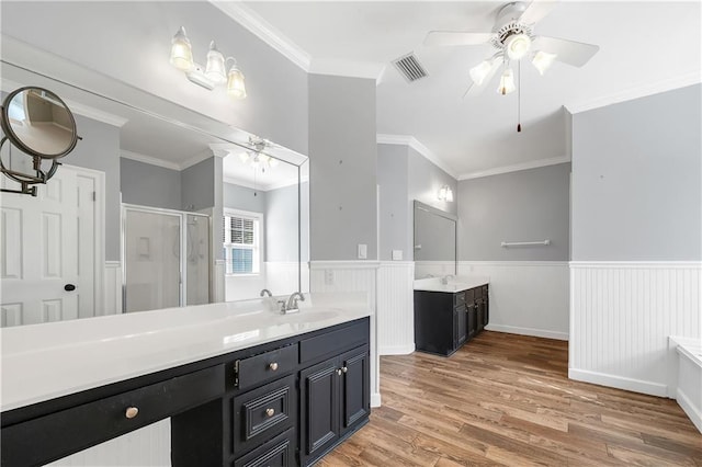 104 Ferncliff Cir, Daphne, AL 36526 - bathroom featuring a shower stall, a wainscoted wall, a ceiling fan, crown molding, and wood finished floors