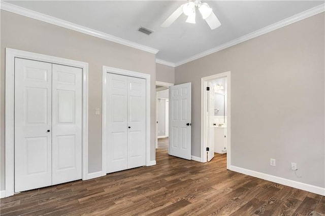 104 Ferncliff Cir, Daphne, AL 36526 - unfurnished bedroom featuring two closets, crown molding, baseboards, dark wood-style flooring, and a ceiling fan