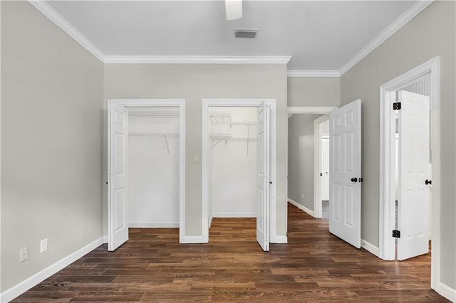 104 Ferncliff Cir, Daphne, AL 36526 - unfurnished bedroom with multiple closets, crown molding, dark wood-style flooring, baseboards, and ceiling fan