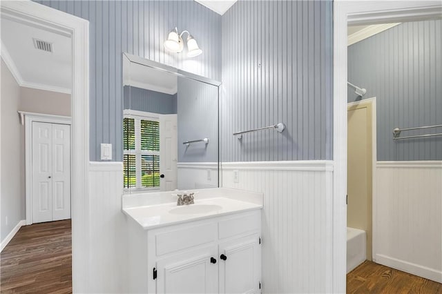 104 Ferncliff Cir, Daphne, AL 36526 - full bathroom with ornamental molding, wood finished floors, vanity, a wainscoted wall, and shower / bathtub combination