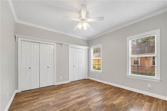 104 Ferncliff Cir, Daphne, AL 36526 - unfurnished bedroom featuring wood finished floors, two closets, baseboards, and crown molding
