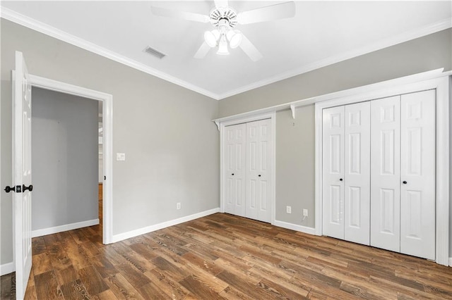 104 Ferncliff Cir, Daphne, AL 36526 - unfurnished bedroom featuring ornamental molding, wood finished floors, multiple closets, baseboards, and a ceiling fan