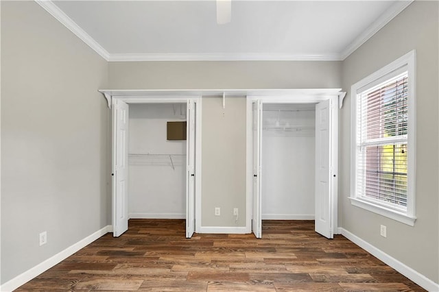 104 Ferncliff Cir, Daphne, AL 36526 - unfurnished bedroom with multiple closets, ornamental molding, wood finished floors, and baseboards